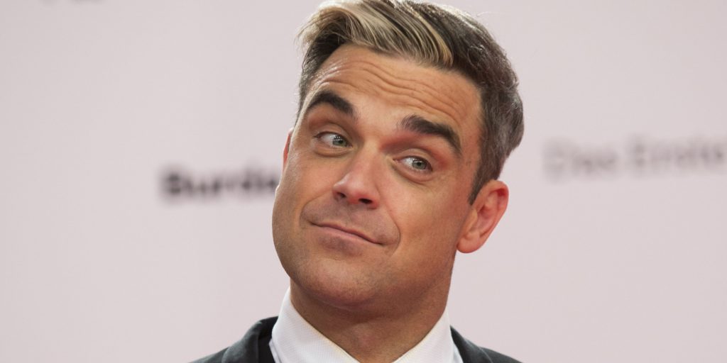 Robbie Williams arrives for the Bambi 2013 media awards in Berlin, Germany, Thursday, Nov. 14, 2013. (AP Photo/Gero Breloer)